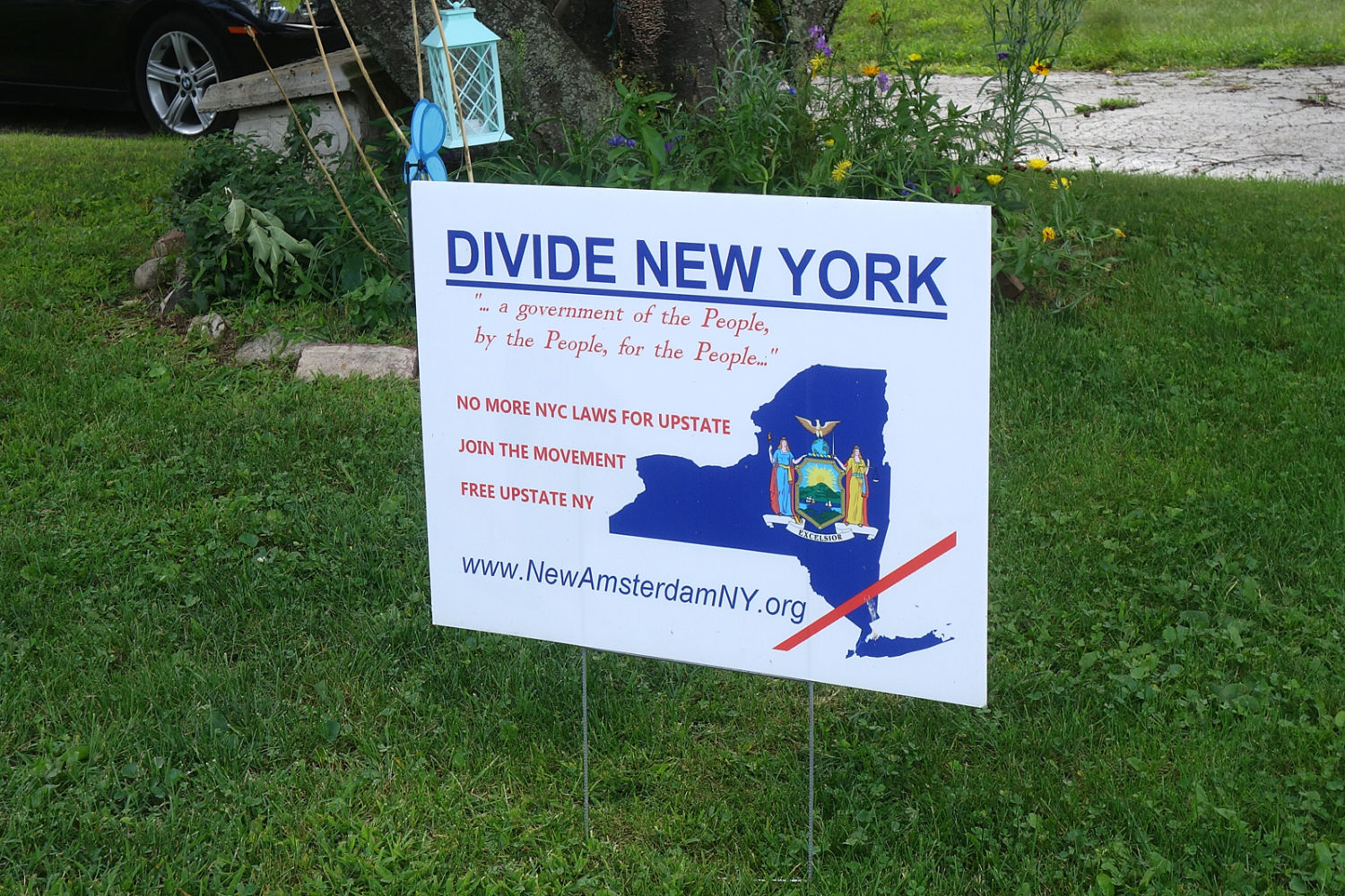 Divide New York sign on lawn in Sea Breeze neighborhood.