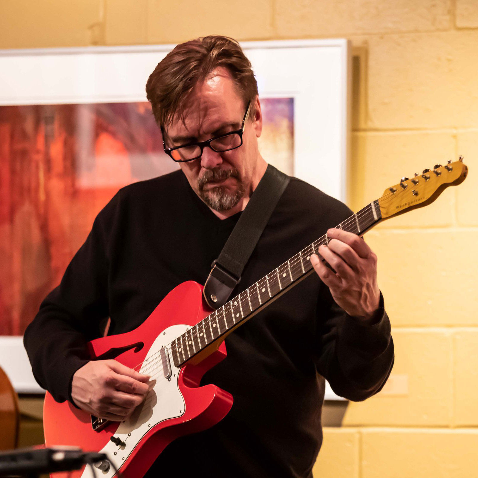 Phil Marshall playing guitar with Margaret Explosion. Photo by Aaron Winters