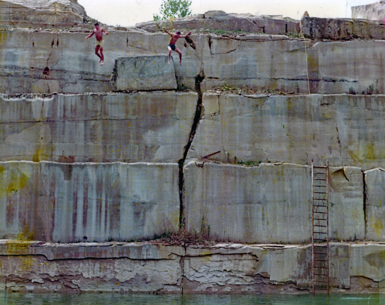 Paul and Fran jumping off edge of quarry 1973