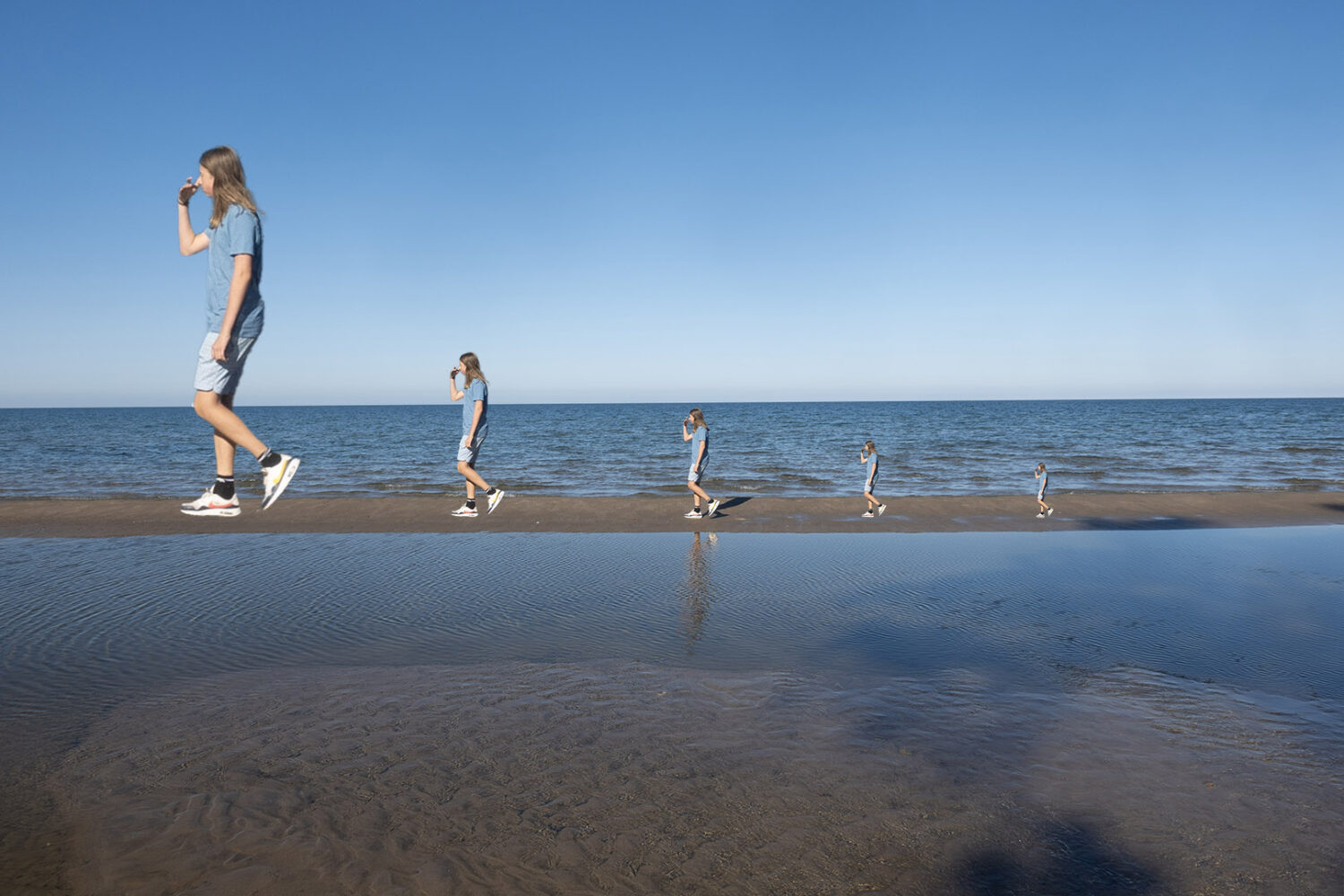 Boy walking on sand bar at Durand