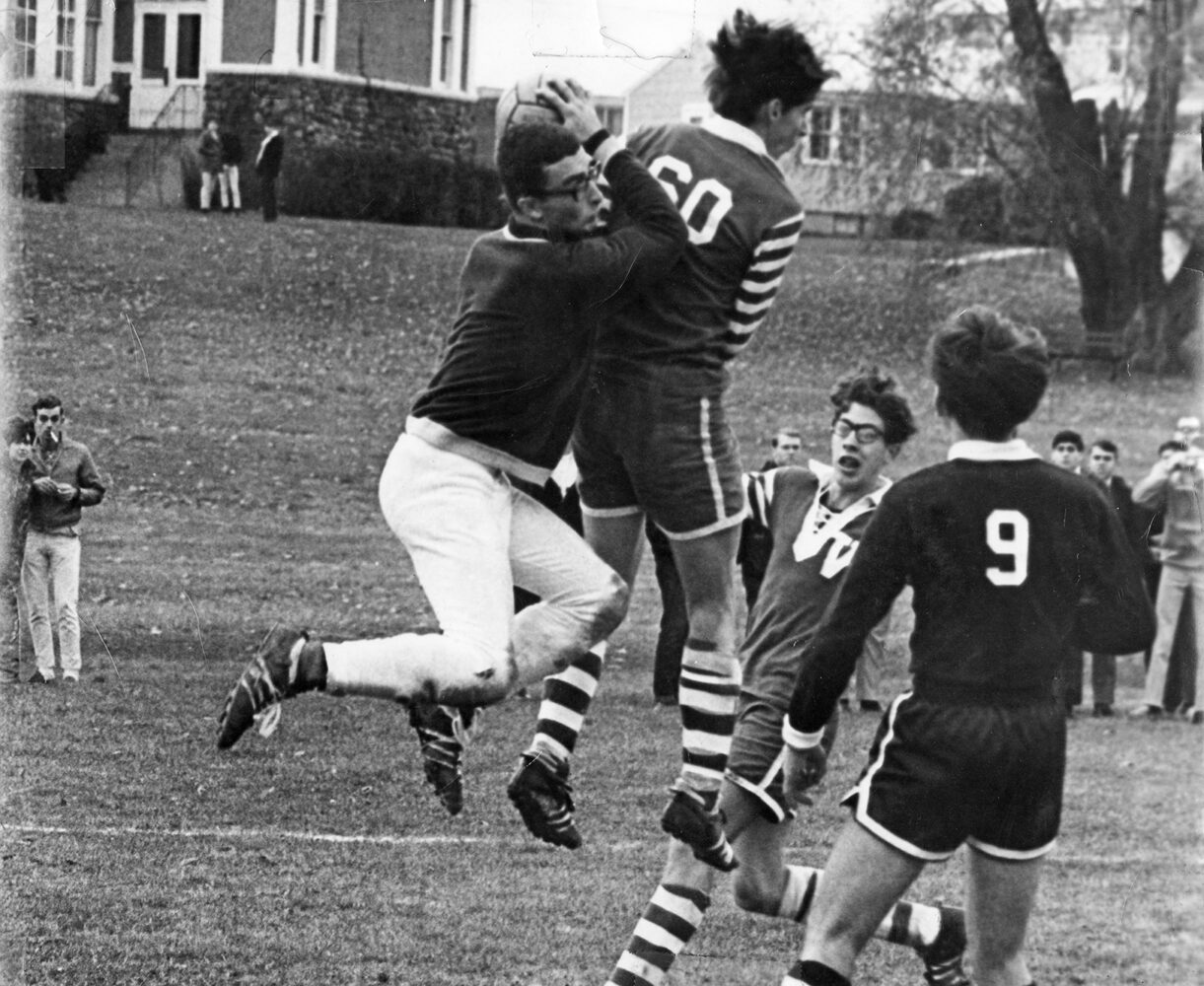 Paul Dodd, number 60, collides with Gate Chili goalie, Tony Mastronato, in Section 5 match. Paul Shriver is facing forward.  1967